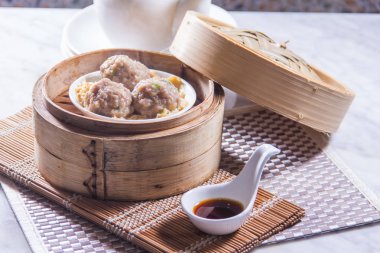 closeup of dim sum in  bamboo steamer 