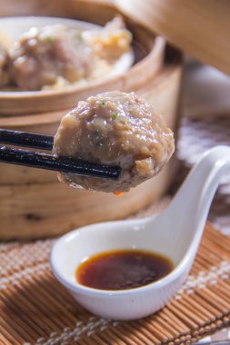 closeup of dim sum in  bamboo steamer 