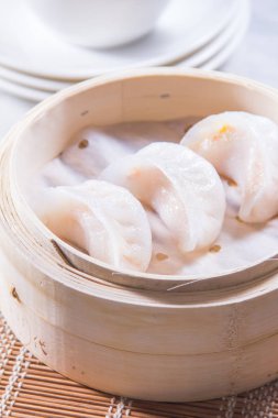 closeup of dim sum in  bamboo steamer 