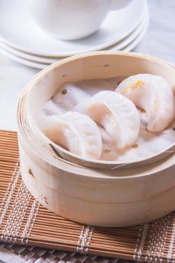 closeup of dim sum in  bamboo steamer 