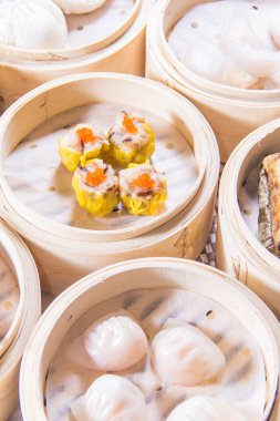 closeup of dim sum in  bamboo steamer 