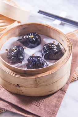 closeup of dim sum in  bamboo steamer 