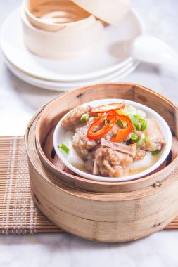 closeup of dim sum in  bamboo steamer 