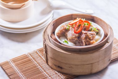 closeup of dim sum in  bamboo steamer 