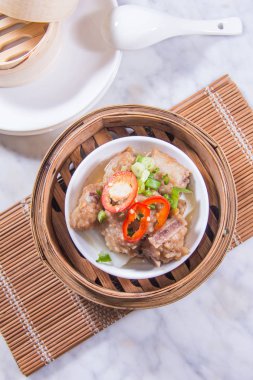 closeup of dim sum in  bamboo steamer 