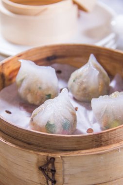 closeup of dim sum in  bamboo steamer 