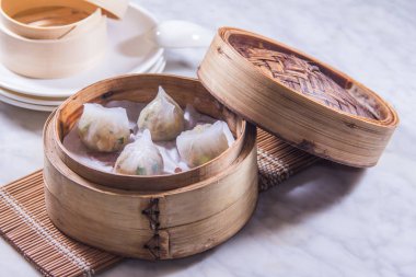 closeup of dim sum in  bamboo steamer 