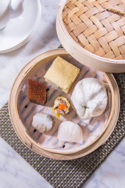 closeup of dim sum in  bamboo steamer 