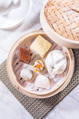 closeup of dim sum in  bamboo steamer 