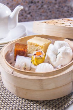 closeup of dim sum in  bamboo steamer 