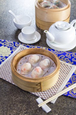 closeup of dim sum in  bamboo steamer 