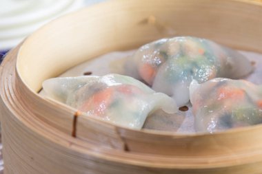 closeup of dim sum in  bamboo steamer 