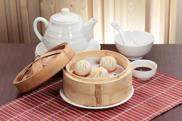 closeup of steamed dumplings in  bamboo steamer - dim sum