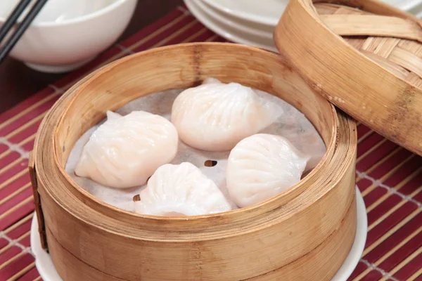 closeup of steamed dumplings in  bamboo steamer - dim sum
