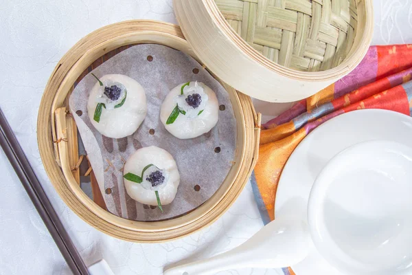closeup of dim sum in  bamboo steamer 