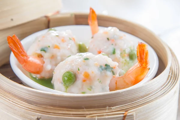 closeup of dim sum in  bamboo steamer 