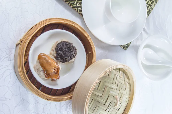 closeup of dim sum in  bamboo steamer 