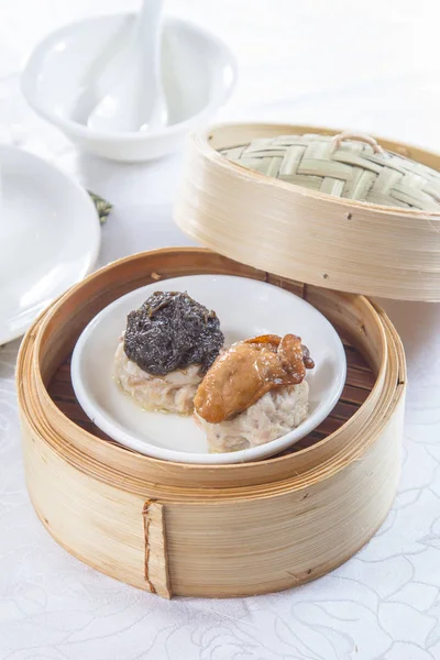 closeup of dim sum in  bamboo steamer 