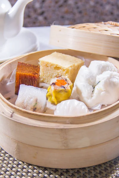 closeup of dim sum in  bamboo steamer 