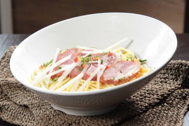 close up of plate of noodles on table  