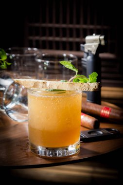 cocktail with lemon and lime in black glass