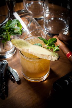 cocktail with mint, lemon, kiwi, lime and ice, black background