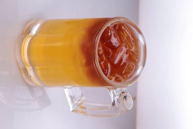 glass of hot tea with ice cream on a white background