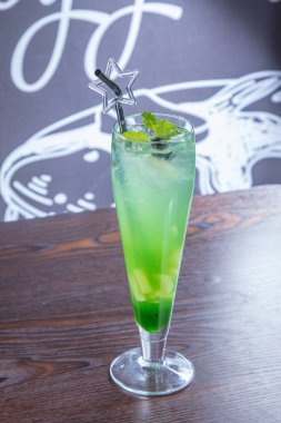 a glass of lemonade with ice and lime