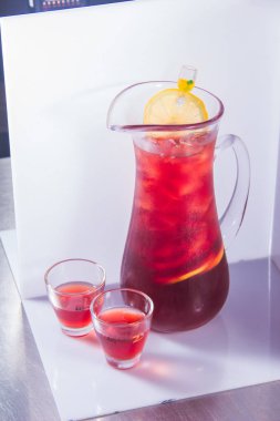 glass of red tea with lemon and mint on a white background
