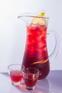 glass of cold tea with lemon and ice cubes on white background