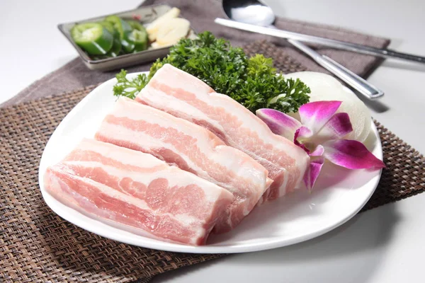closeup of raw pork on plate 