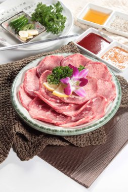closeup of raw meat slices on plate 