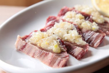 closeup of raw pork on plate 