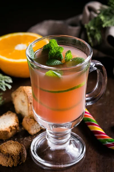 Festive Cranberry drink on Christmas background with fir branches and fresh berries, selective focus. Holiday concept. Dark stone table, Winter time — Stock Photo, Image