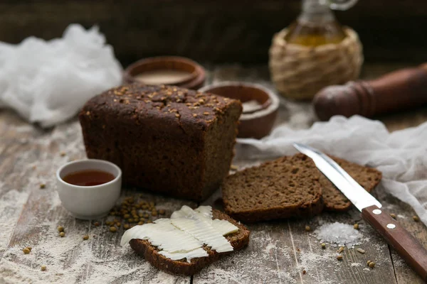 Butter and bread for breakfast over rustic wooden background.