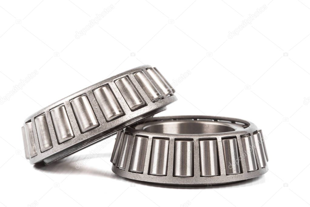 Two precision metal bearings on a white background