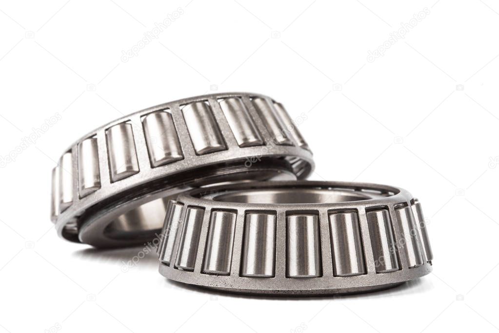 Two precision metal bearings on a white background