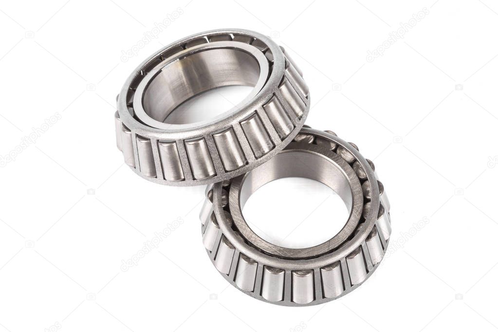 Two precision metal bearings on a white background