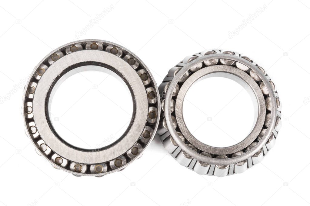 Two precision metal bearings on a white background. top view