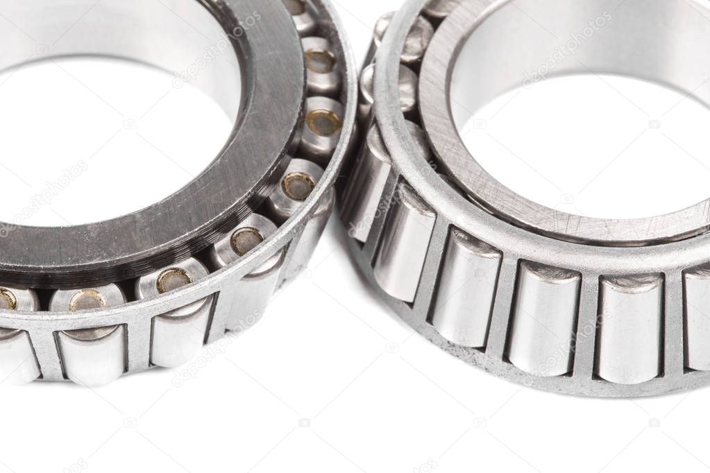 Two precision metal bearings on a white background. Close up