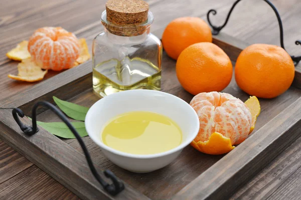Tangerine essential oil in a glass bottle — Stock Photo, Image