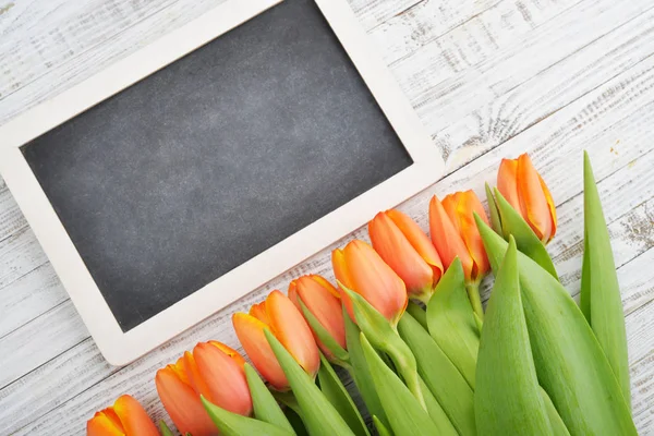 Red tulips with chalkboard — Stock Photo, Image