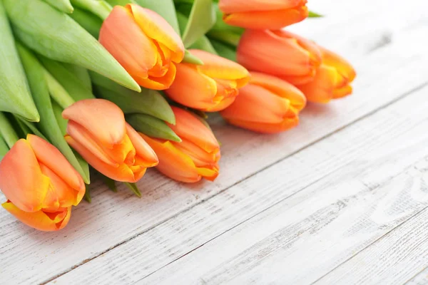 Red tulips on wooden background — Stock Photo, Image