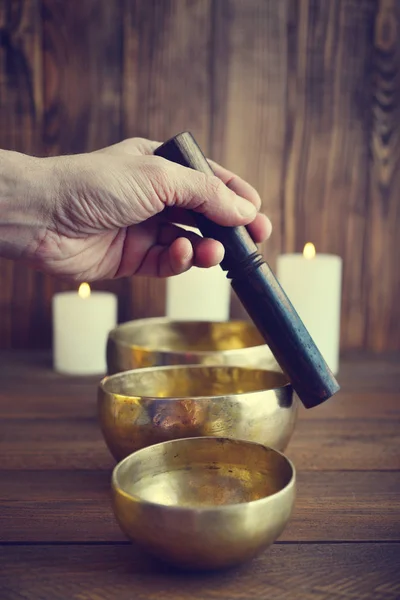 Male hand playing on Tibetan singing bowls — Stock Photo, Image