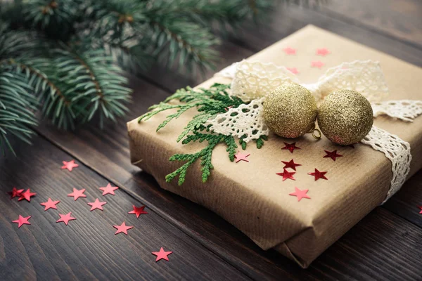Christmas gift with fir tree twig — Stock Photo, Image