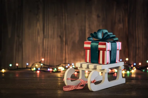 Gift boxes with ribbons on sled — Stock Photo, Image