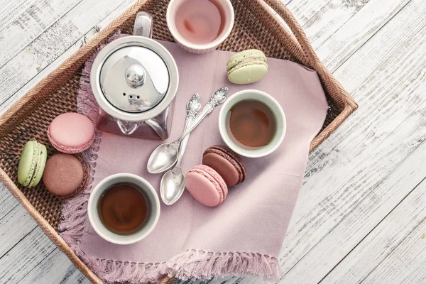 Different kinds of macaroons with glass teapot — Stock Photo, Image