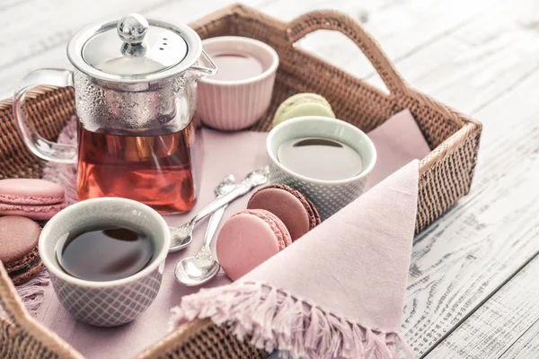 Different kinds of macaroons with glass teapot — Stock Photo, Image