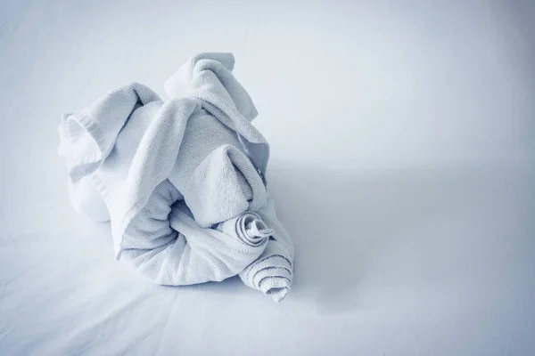 Dog shaped towel on the bed — Stock Photo, Image