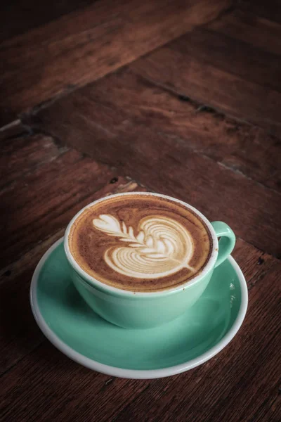 En kopp kaffe med latte konst ovanpå — Stockfoto